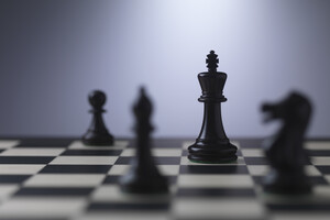 Chess-pieces-on-a-board-showing-king_GettyImages-480810991.jpg